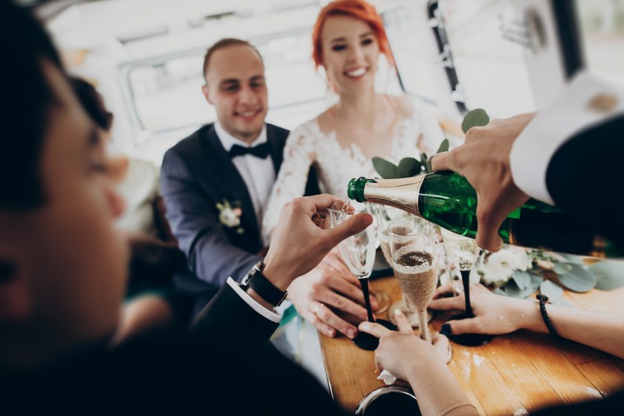 stylish-happy-bride-and-groom-toasting-with-glasses-of-champagne-and-having-fun.jpg